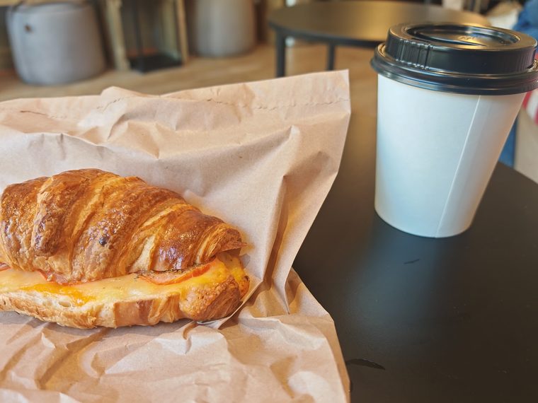Ham and cheese croissant served in paper